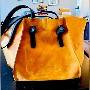 Re-sizable tote bag in rich mustard color. Beautiful sturdy leather.